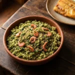Arroz de cuxá tradicional com vinagreira, camarão seco e gergelim servido em tigela de barro.